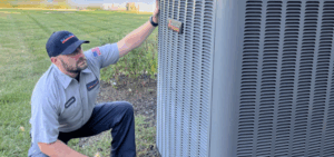 No Problem Heating & Cooling Worker performing air conditioning services in St. Peters, MO.