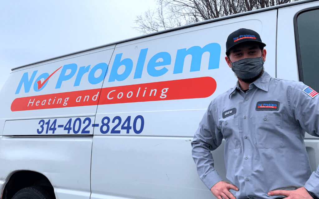 HVAC technician in front of No Problem Heating and Cooling truck