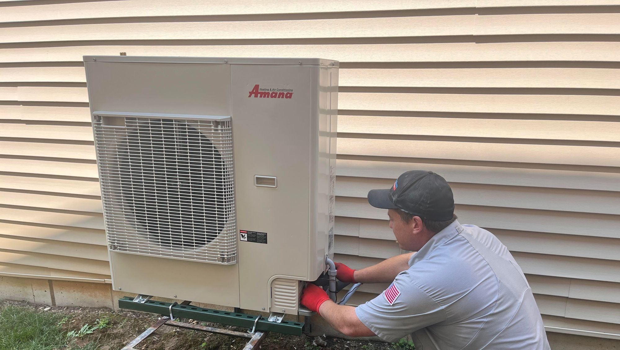 No problem heating & cooling worker outside a house providing heat pump services in St. Peters, MO.