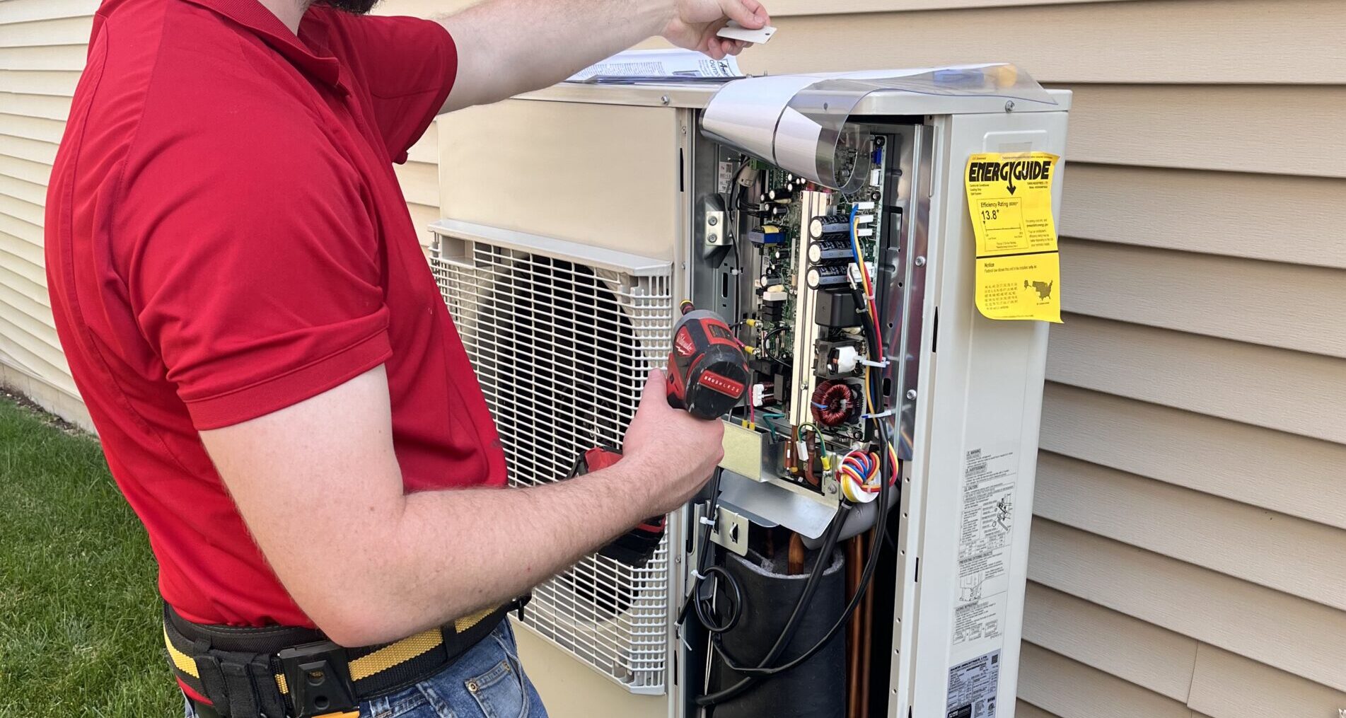 Worker outside a house providing heat pump services in St. Peters, MO